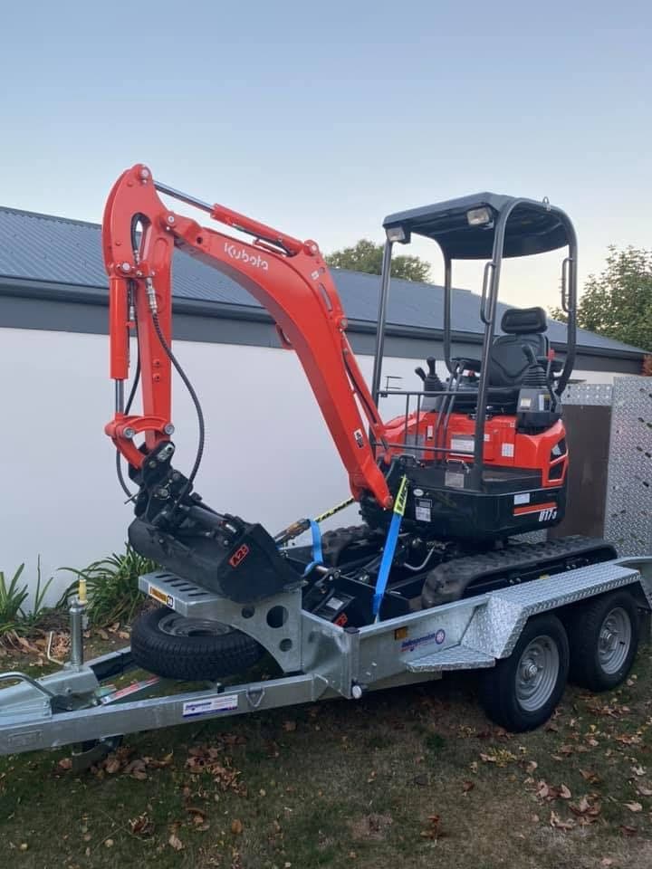 Kubota U17-3 mini excavator loaded on its included tandem trailer